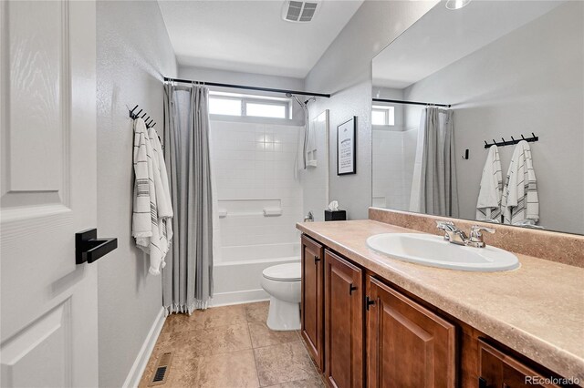 full bathroom featuring tile patterned flooring, vanity, shower / tub combo, and toilet