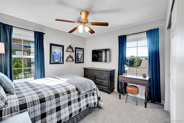 bedroom featuring ceiling fan and light carpet