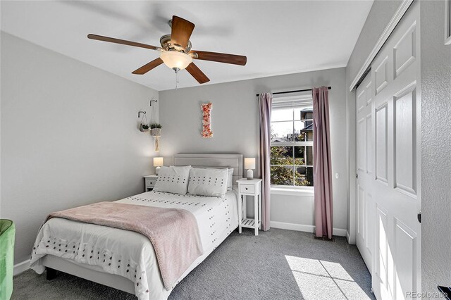 bedroom featuring light colored carpet, a closet, and ceiling fan