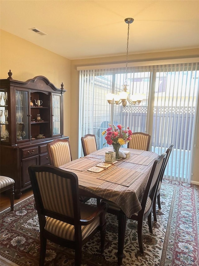 dining space featuring an inviting chandelier