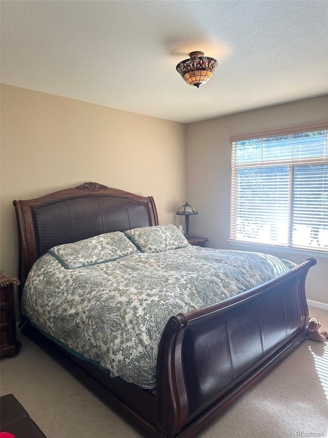 carpeted bedroom featuring a textured ceiling