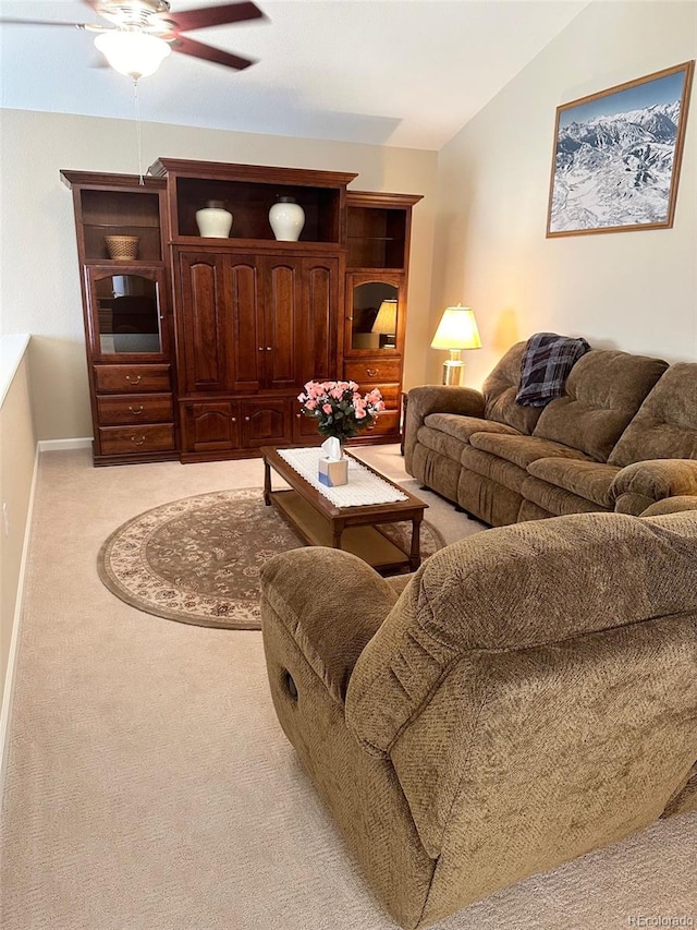 living room with lofted ceiling, light colored carpet, and ceiling fan