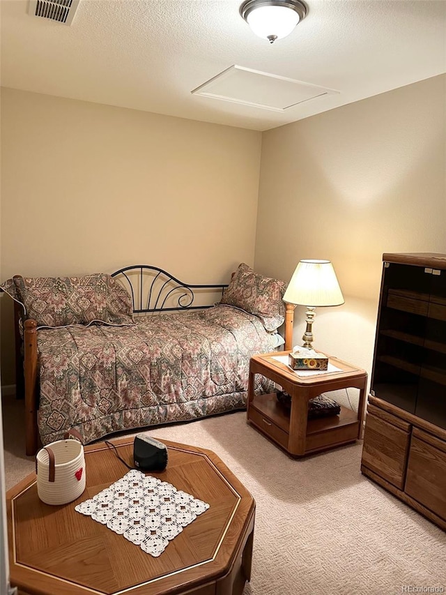 bedroom featuring a textured ceiling and carpet floors