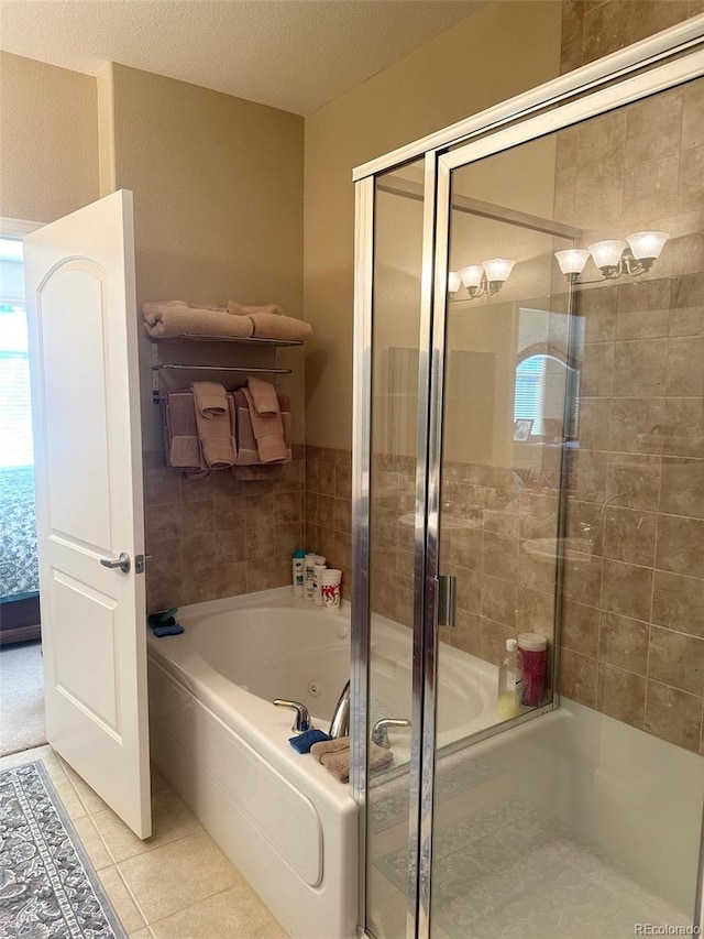 bathroom with independent shower and bath, a textured ceiling, and tile patterned flooring