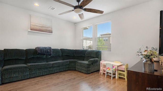 living room with ceiling fan and light wood-type flooring