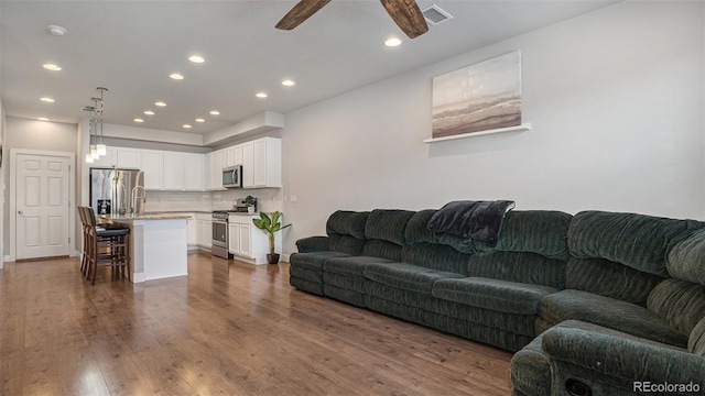 16231 E Warner Pl, Denver, CO 80239 - living area with a ceiling fan, recessed lighting, and dark wood finished floors