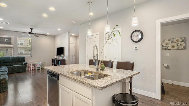16231 E Warner Pl, Denver, CO 80239 - kitchen with stainless steel dishwasher, open floor plan, a ceiling fan, a kitchen island with sink, and light stone countertops