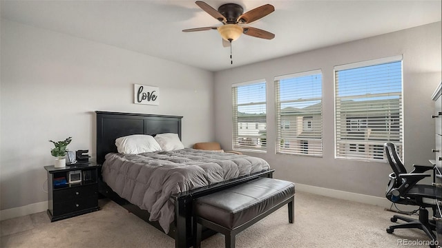 bedroom featuring light colored carpet and ceiling fan