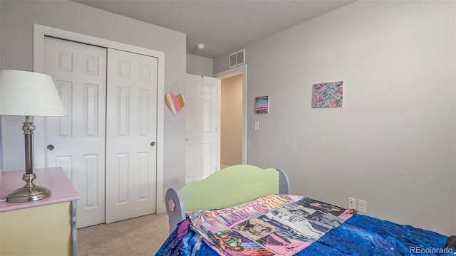 carpeted bedroom with a closet