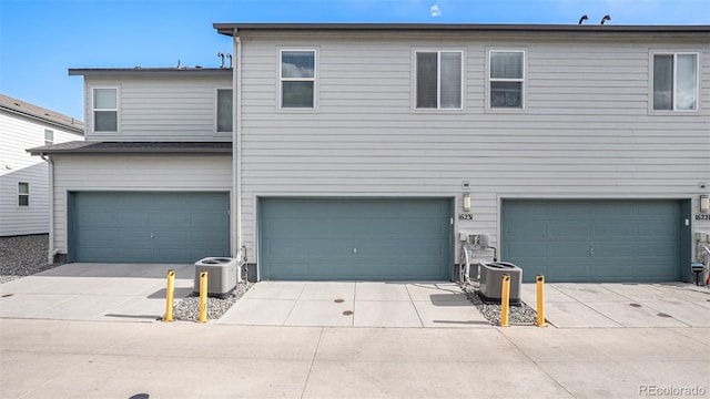 view of front facade with a garage and cooling unit