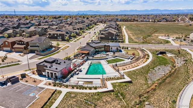 16231 E Warner Pl, Denver, CO 80239 - aerial perspective of suburban area featuring a pool area and mountains