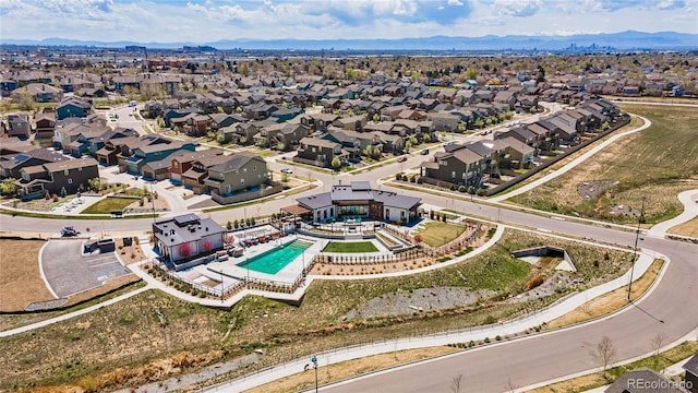 16231 E Warner Pl, Denver, CO 80239 - aerial perspective of suburban area with a pool area and a mountain backdrop