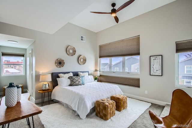 bedroom with multiple windows, baseboards, visible vents, and carpet floors