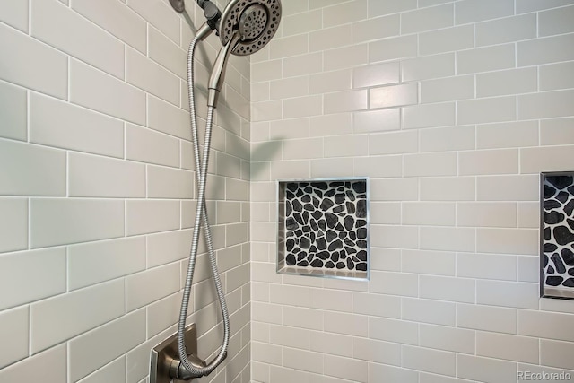 bathroom with a tile shower