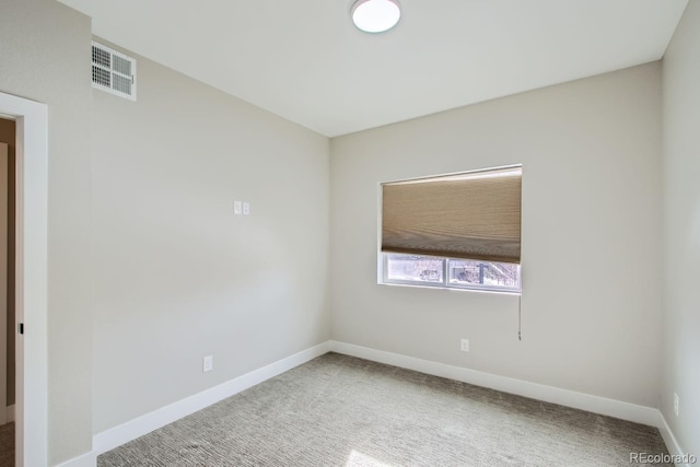 unfurnished room featuring visible vents, baseboards, and carpet