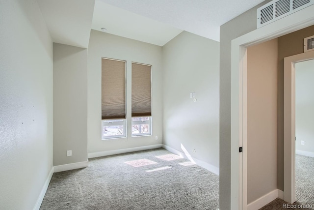 empty room with visible vents, carpet floors, and baseboards