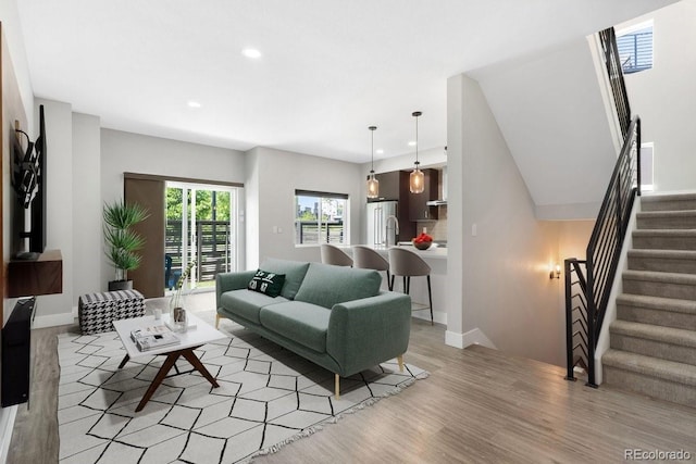 2804 W 53rd Ave, Denver, CO 80221 - living room with light wood-type flooring, recessed lighting, stairs, and baseboards