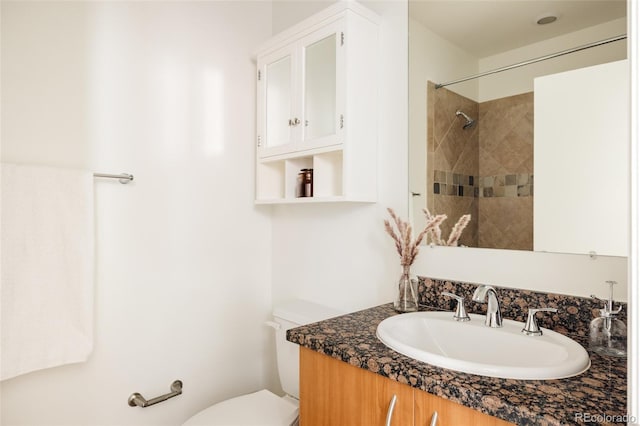 2680 Blake St Unit 12, Denver, CO 80205 - bathroom featuring vanity, toilet, and tiled shower
