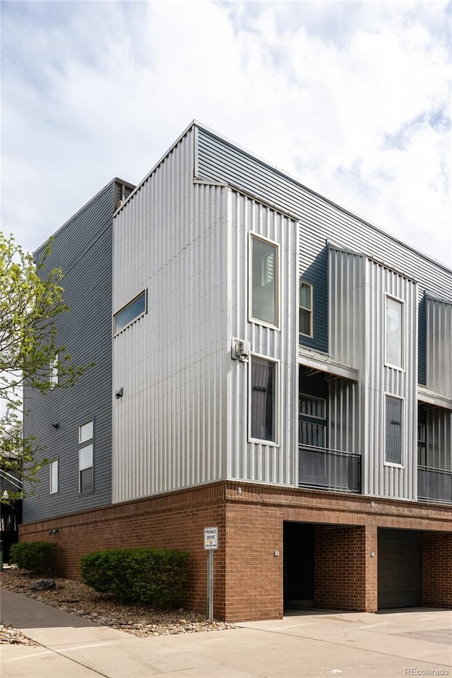2680 Blake St Unit 12, Denver, CO 80205 - view of building exterior with a garage and concrete driveway