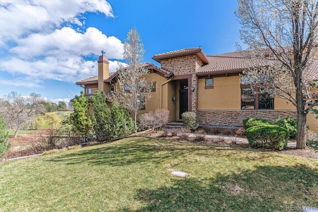 7850 Vallagio Ln, Englewood, CO 80112 - mediterranean / spanish home with a tile roof, stucco siding, stone siding, and a front lawn