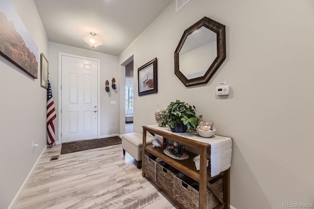 entryway with light hardwood / wood-style floors