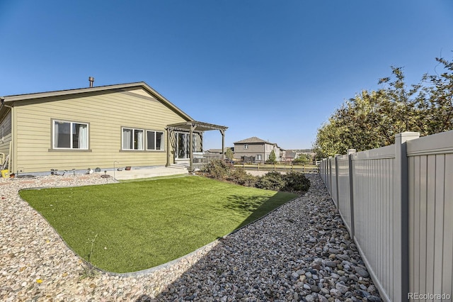 rear view of house featuring a lawn, a pergola, and a patio area