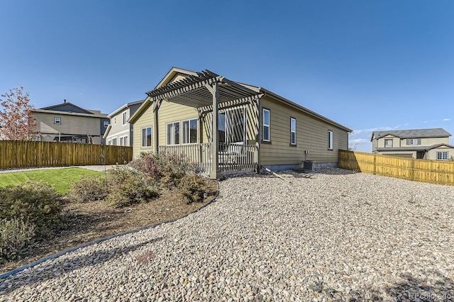 back of property with central air condition unit and a pergola