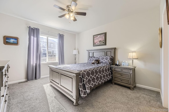 bedroom featuring light colored carpet and ceiling fan