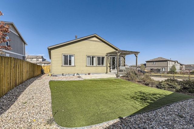 back of house with a pergola, a yard, and a patio area