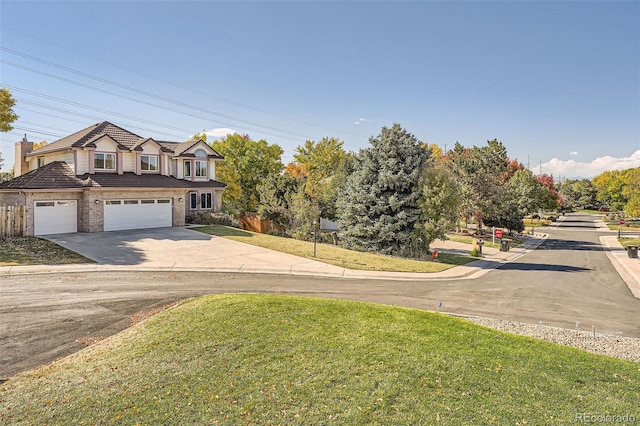 view of front facade with a garage and a front lawn