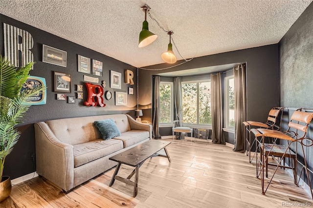 living area featuring a textured ceiling and hardwood / wood-style flooring