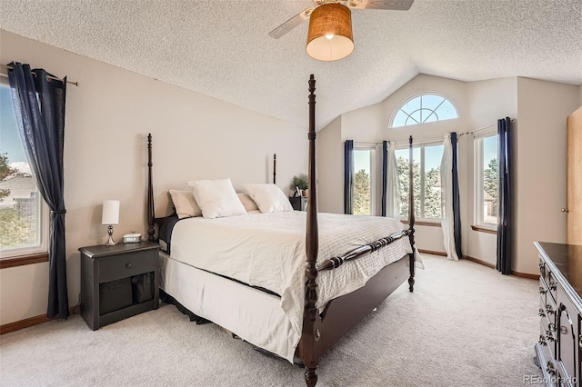 carpeted bedroom featuring lofted ceiling, a textured ceiling, and ceiling fan