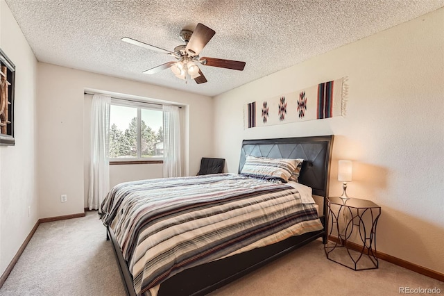 carpeted bedroom with a textured ceiling and ceiling fan