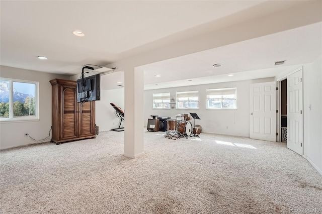 interior space with light colored carpet and a wealth of natural light