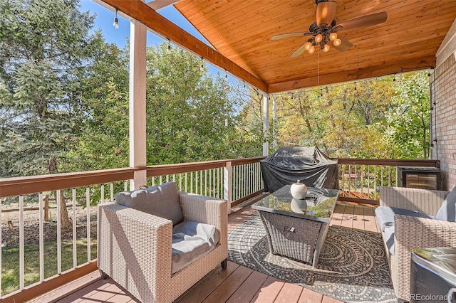 wooden deck with a grill and ceiling fan