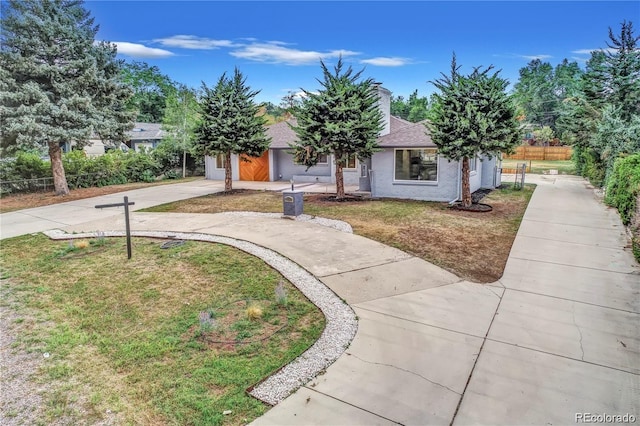 obstructed view of property with a front yard