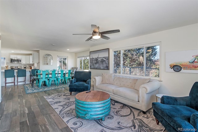 living room featuring hardwood / wood-style floors and ceiling fan