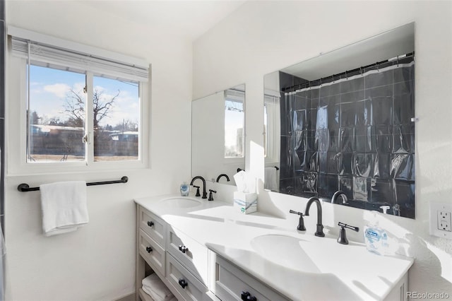 bathroom featuring vanity and curtained shower