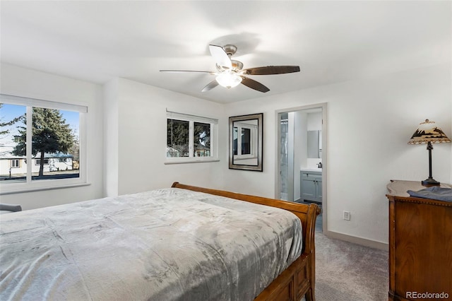 bedroom featuring ensuite bath, ceiling fan, and carpet