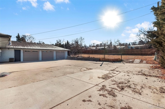 exterior space featuring central AC and a garage