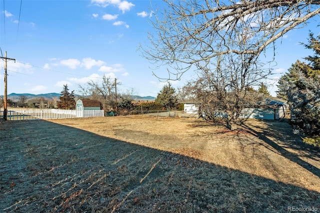 view of yard with a mountain view and a rural view