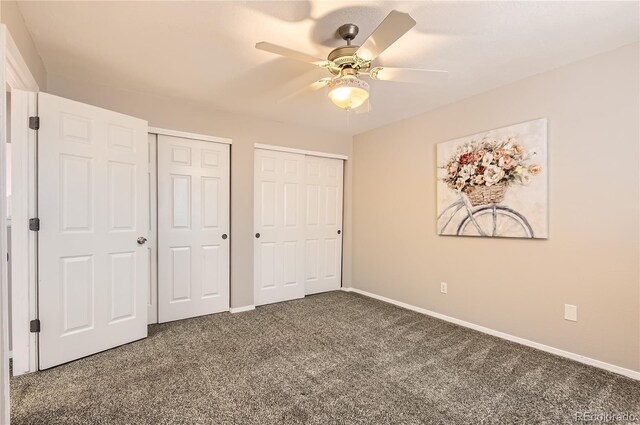 8432 S Upham Way, Littleton, CO 80128 - unfurnished bedroom with two closets, carpet flooring, and ceiling fan
