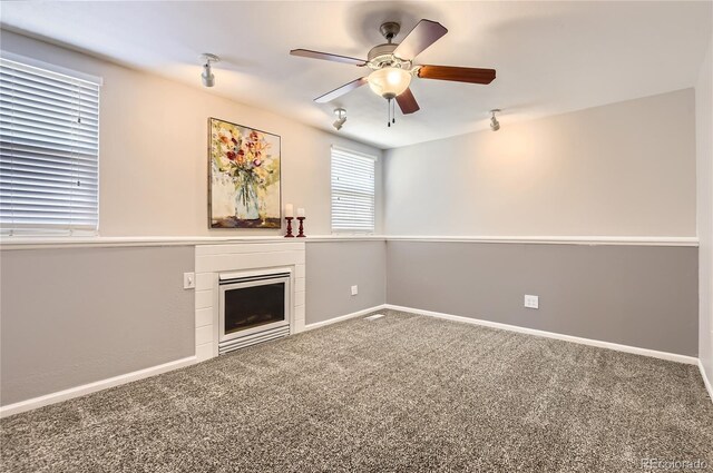 8432 S Upham Way, Littleton, CO 80128 - unfurnished living room with a fireplace, ceiling fan, carpet, and rail lighting