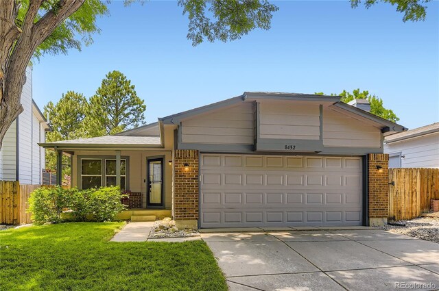 8432 S Upham Way, Littleton, CO 80128 - ranch-style house featuring brick siding, an attached garage, and concrete driveway
