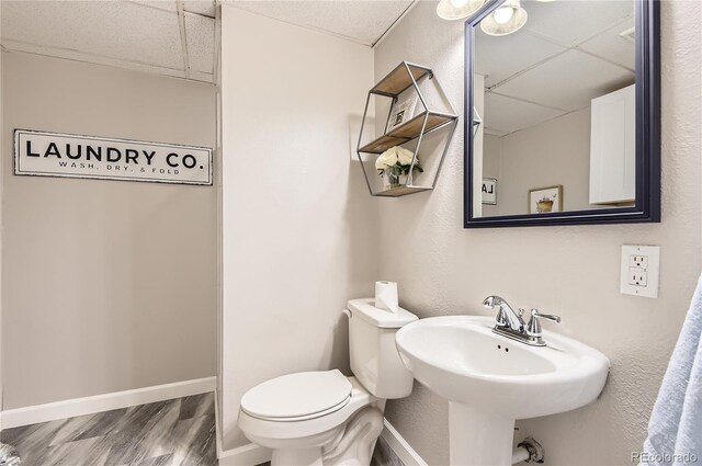 8432 S Upham Way, Littleton, CO 80128 - half bathroom with a drop ceiling and wood finished floors