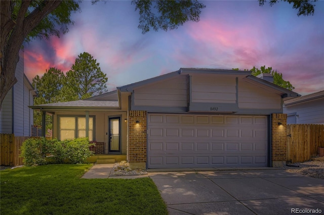 8432 S Upham Way, Littleton, CO 80128 - single story home featuring brick siding, an attached garage, and driveway