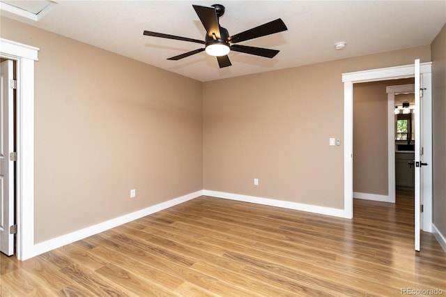 spare room featuring light hardwood / wood-style flooring and ceiling fan