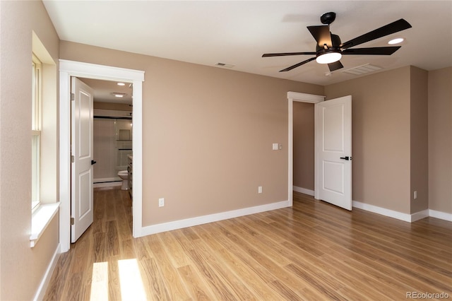 unfurnished bedroom featuring light wood-type flooring, ceiling fan, and ensuite bathroom