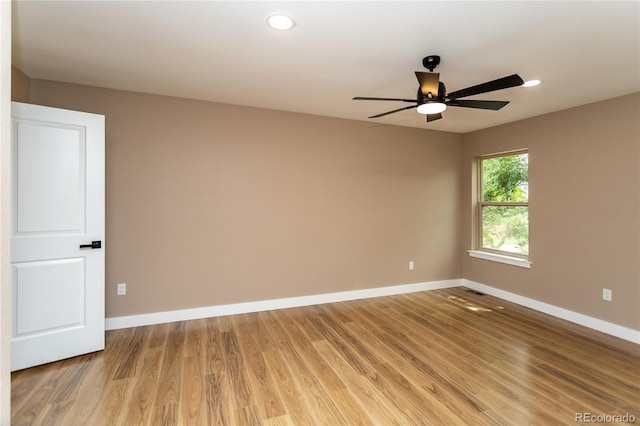 spare room featuring light hardwood / wood-style flooring and ceiling fan