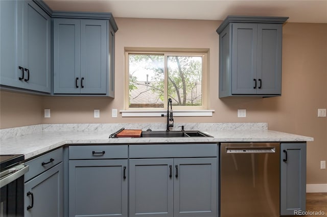 kitchen featuring dishwasher, hardwood / wood-style floors, and sink